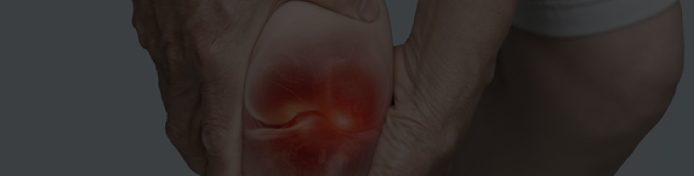 Man holding painful joint with both hands and red glowing light showing inflammation — representing joint soreness and discomfort for desktop view