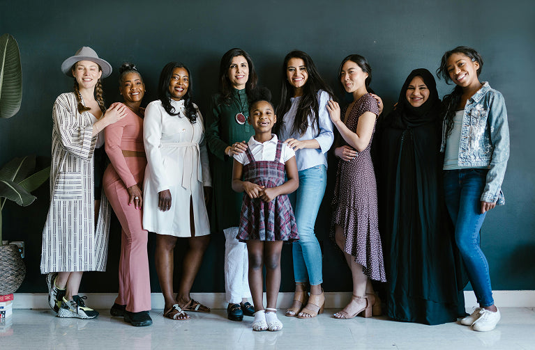 About Us banner showing 9 women from different backgrounds, including Black, Brown, and Muslim, smiling and standing together, highlighting diversity and unity on Brit Finds desktop page