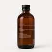 Back side of Brit Finds 100 ml wrap kit oil bottle with simple cap design showing detailed label including ingredients and usage instructions 
