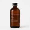 Back side of Brit Finds 100 ml wrap kit oil bottle with simple cap design showing detailed label including ingredients and usage instructions 
